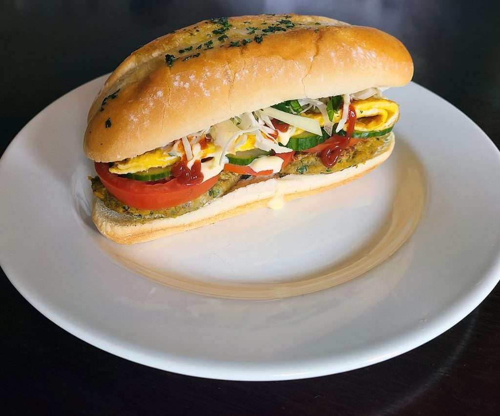 Anday Wala Burger (Sandwich with Lentil Patties, Egg, Salad, Ketchup, and Mayo)
